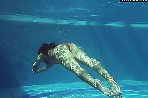 Kittina swims naked in the swimming pool