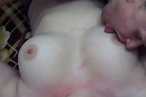 Husband licks his young wife's big natural tits and hard nipples