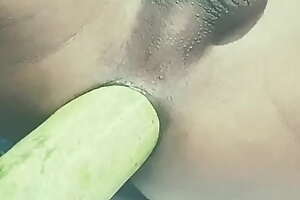 Asian twink puts vegetable cucumber in anal hole
