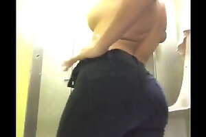 Dancing and teasing in a public toilet