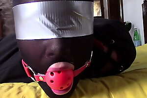 Laura XXX is wearing panthyhose and high heels  She's hogtied, masked, blindfolded and ballgagged